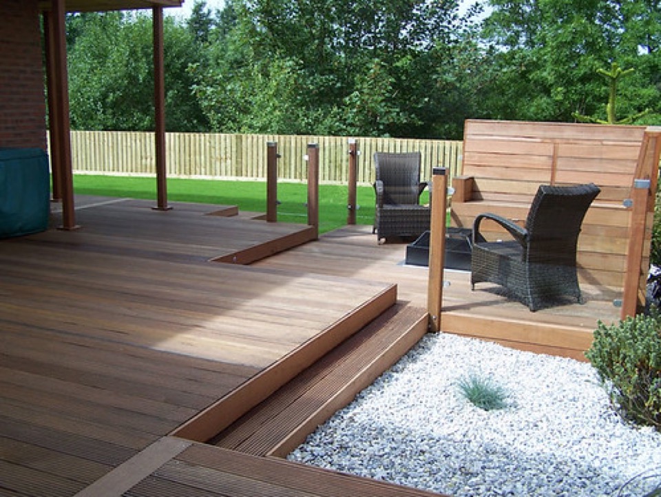 A timber deck with timber posts and a slatted timber screen in a back garden